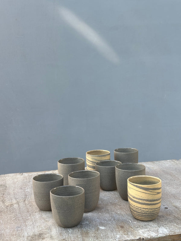 grey cappuccino cups in a collection of cups