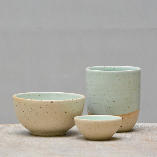 pastel green tableware made out of speckled clay