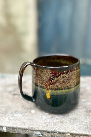 a 500 ml mug in glossy black and goldstone glaze
