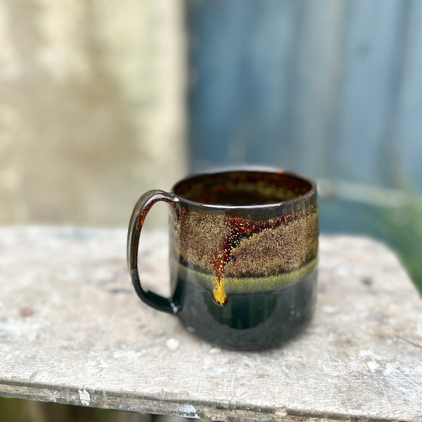 a 500 ml mug in glossy black and goldstone glaze
